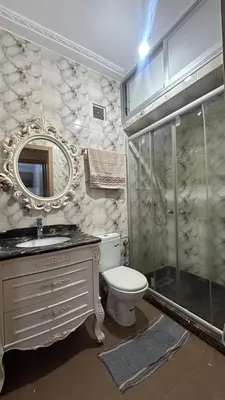 a bathroom with a toilet and a sink and a shower at Cozy Sunny Apartment Near Beach nd Local Amenities in Dar Ben Abdallah Ben Dehbi