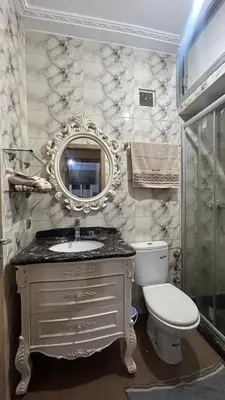 a bathroom with a sink and a toilet and a mirror at Cozy Sunny Apartment Near Beach nd Local Amenities in Dar Ben Abdallah Ben Dehbi