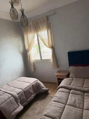 a bedroom with a bed and a window at Cozy Sunny Apartment Near Beach nd Local Amenities in Dar Ben Abdallah Ben Dehbi