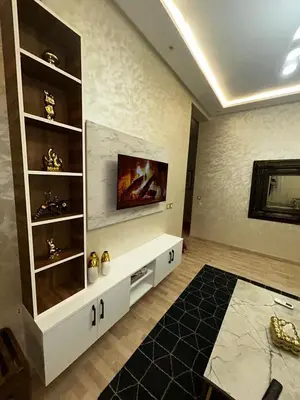 a living room with a tv on a wall at Cozy Apt Near Train Station in Rabat