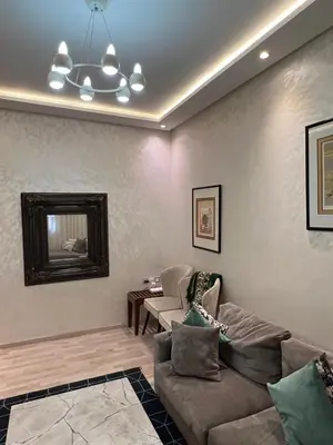 a living room with a couch and a table at Cozy Apt Near Train Station in Rabat