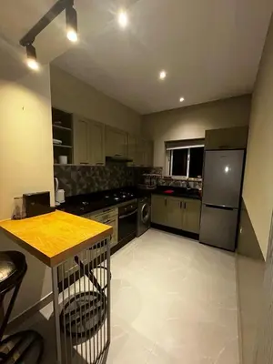 a kitchen with stainless steel appliances and a counter at Cozy Apt Near Train Station in Rabat