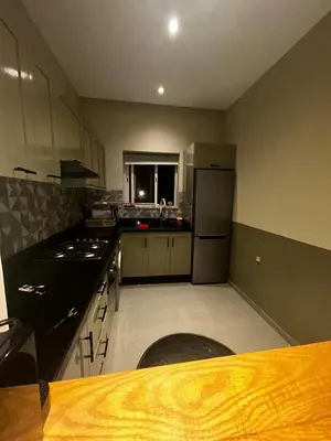 a kitchen with a refrigerator and a window in it at Cozy Apt Near Train Station in Rabat