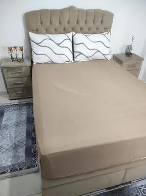 a bed with two pillows on it in a bedroom at appart a 5min de l'hôpital Mohamed 6 in Casablanca