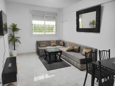 a living room with a couch and a table at appart a 5min de l'hôpital Mohamed 6 in Casablanca