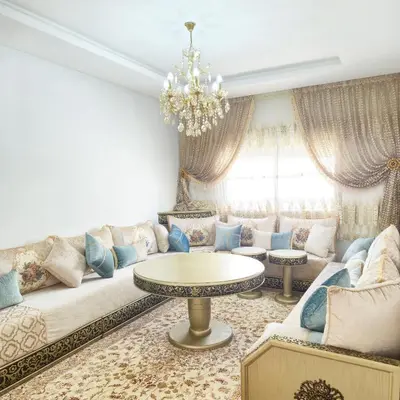 a living room with a couch and a table at Appartement familial au quartier des Hôpitaux in Casablanca