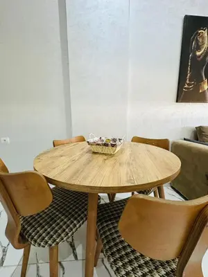 a wooden table with chairs and a bowl on top at Residence Carlton House2 STUDIOS in Roches Noires