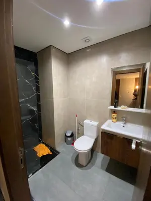 a bathroom with a toilet and a sink and a shower at Residence Carlton House2 STUDIOS in Roches Noires
