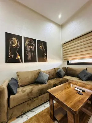 a living room with a couch and a table at Residence Carlton House2 STUDIOS in Roches Noires
