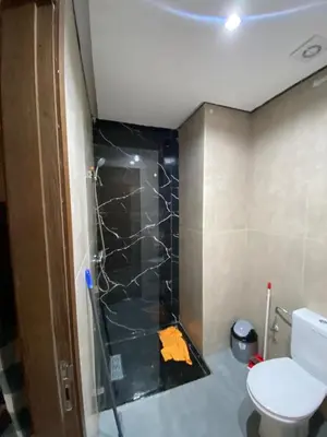 a bathroom with a shower and a toilet in it at Residence Carlton House2 STUDIOS in Roches Noires