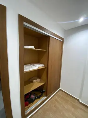 a closet with a door open in a room at Residence Carlton House2 STUDIOS in Roches Noires