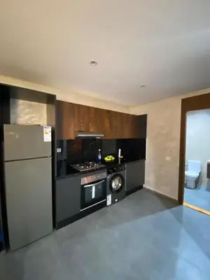 a kitchen with a stove and a refrigerator in it at Residence Carlton House2 STUDIOS in Roches Noires