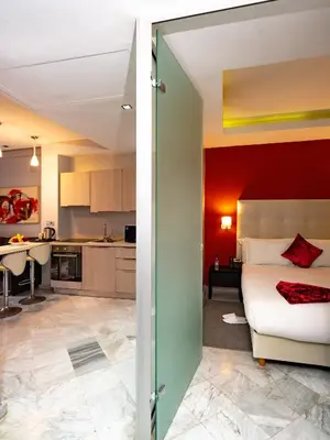 a bedroom and a kitchen with a bed and a table at The Fourteen Luxury Boutique Hotel & SPA in Casablanca