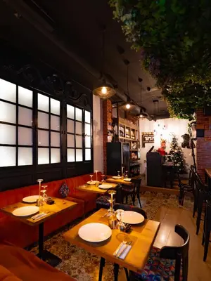 a restaurant with wooden tables and chairs and windows at The Fourteen Luxury Boutique Hotel & SPA in Casablanca