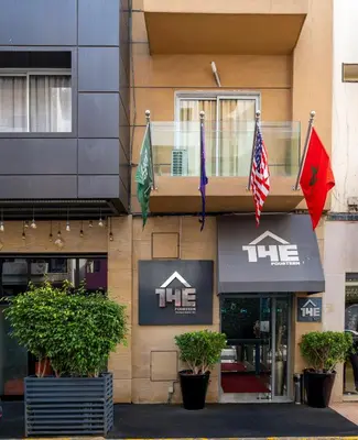 a building with flags on the side of it at The Fourteen Luxury Boutique Hotel & SPA in Casablanca
