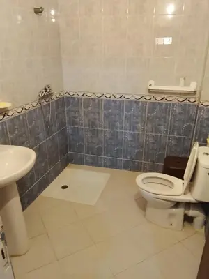 a bathroom with a toilet and a sink at Razzak in Rabat