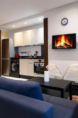a living room with a couch and a fireplace at Studio design et cosy au centre ville in Casablanca