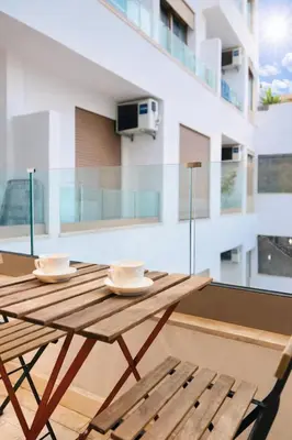 a wooden table and chairs on a balcony at Studio design et cosy au centre ville in Casablanca