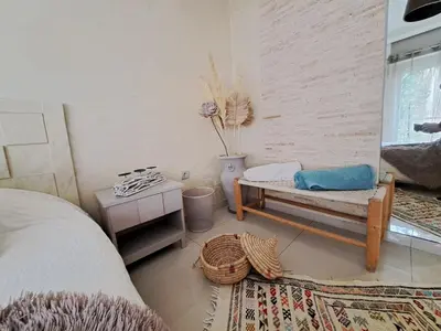 a bedroom with a bed and a bench and a table at Central Downtown Free Parcking AC in Casablanca