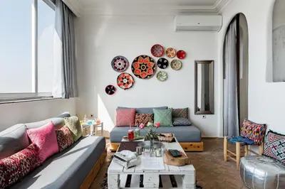 a living room with a couch and plates on the wall at Charming Moroccan Studio, Breathtaking View in Casablanca