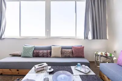 a couch in a living room with windows at Charming Moroccan Studio, Breathtaking View in Casablanca