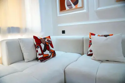 a white couch with two pillows on it at Evasion chic et central au coeur de Maarif in Casablanca