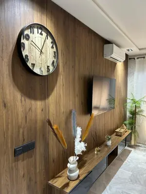a clock on a wooden wall in a room at Evasion chic et central au coeur de Maarif in Casablanca