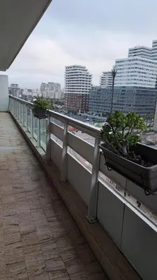 a balcony with two potted plants on the ledge at Luxury Appart Finance City in Casablanca