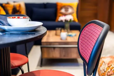 a table with a bowl of food on it and a chair at Luxury one bedroom in Triangle d'or with rooftop pool in Casablanca