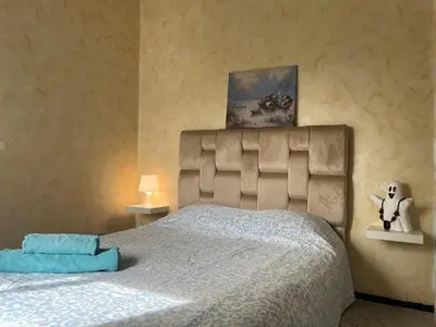 a bedroom with a bed and a painting on the wall at Chambre Cosy - Accès Côte et Plage Mohammedia, Centre-Ville Mohammedia à Pied - Résidence 3 Mars in Mohammedia