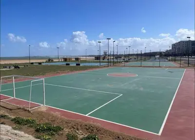 an empty tennis court with a tennis court at Chambre Cosy - Accès Côte et Plage Mohammedia, Centre-Ville Mohammedia à Pied - Résidence 3 Mars in Mohammedia