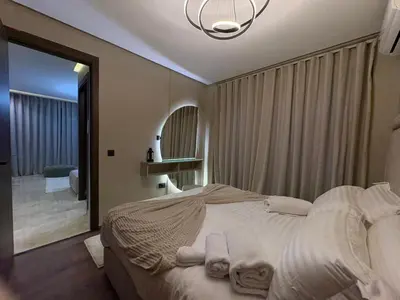 a bedroom with a large bed with towels on it at Premium Studio Oasis Secure Parking High Speed Fiber Wifi Luxoria Oasis Residence Near CFC & 70p Smart TV in Casablanca