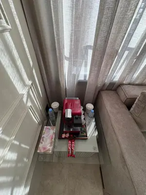 a small room with a couch and a table at Premium Studio Oasis Secure Parking High Speed Fiber Wifi Luxoria Oasis Residence Near CFC & 70p Smart TV in Casablanca