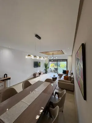 a living room with a large wooden table and chairs at Premium 2 Bedroom Suite Maarif Central & High-Speed Wi-Fi Fully Equipped Walk to Twin Center & Shops Next to Carrefour Val Fleuri Family-Friendly in Casablanca