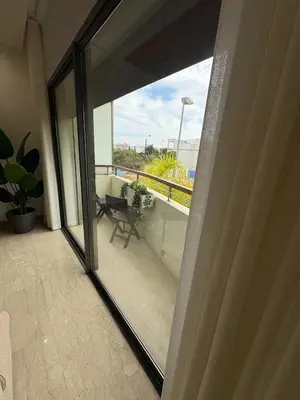 a sliding glass door of a balcony with a view at Premium 2 Bedroom Suite Maarif Central & High-Speed Wi-Fi Fully Equipped Walk to Twin Center & Shops Next to Carrefour Val Fleuri Family-Friendly in Casablanca
