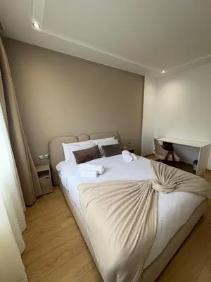 a bedroom with a large bed with towels on it at Premium 2 Bedroom Suite Maarif Central & High-Speed Wi-Fi Fully Equipped Walk to Twin Center & Shops Next to Carrefour Val Fleuri Family-Friendly in Casablanca