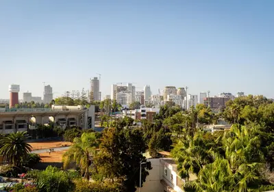 a cityscape of a city with buildings and palm trees at Studio Balcony Netflix, Near CFC, Parking in Casablanca