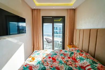 a bedroom with a bed and a view of a balcony at Studio Balcony Netflix, Near CFC, Parking in Casablanca