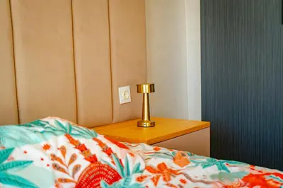 a bedroom with a bed and a lamp on a table at Studio Balcony Netflix, Near CFC, Parking in Casablanca