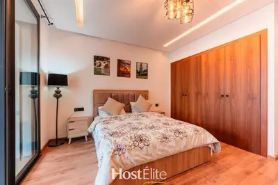 a bedroom with a bed with a wooden headboard at CFC Elegance & Terrace & Fitness & Parking in Casablanca