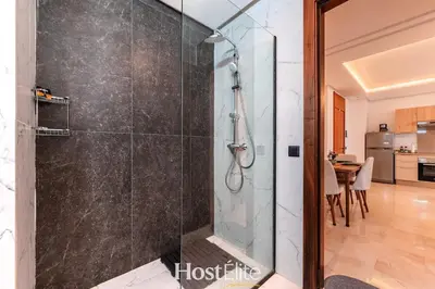 a shower with a glass door in a bathroom at CFC Elegance & Terrace & Fitness & Parking in Casablanca