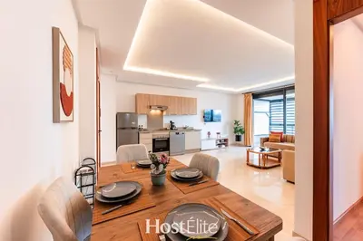 a dining room and living room with a wooden table at CFC Elegance & Terrace & Fitness & Parking in Casablanca
