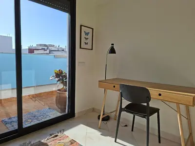 a desk and a chair in a room with a window at Private and sunny apartment in central Casa in Casablanca