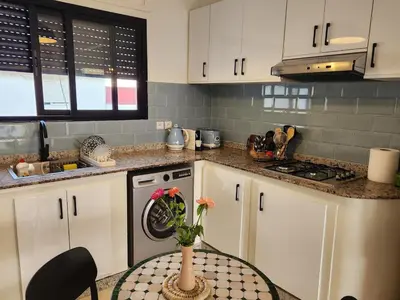 a kitchen with a table with a vase on it at Private and sunny apartment in central Casa in Casablanca