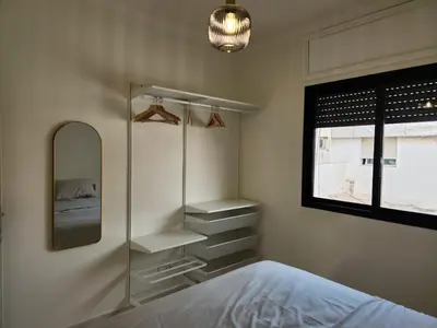 a bedroom with a bed and a mirror and a window at Private and sunny apartment in central Casa in Casablanca