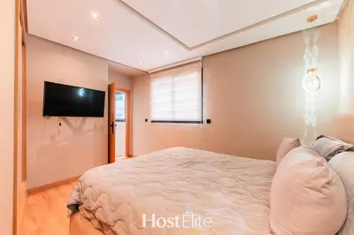 a bedroom with a bed and a flat screen tv at Give Essalam Design & Patio & Clim & 2P in Casablanca