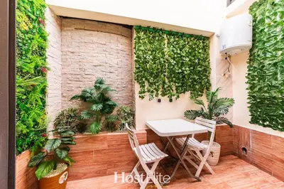 a table and chairs on a balcony with plants at Give Essalam Design & Patio & Clim & 2P in Casablanca