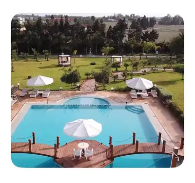 an image of a pool with umbrellas and chairs at La Hacienda De Morafia in Bouskoura
