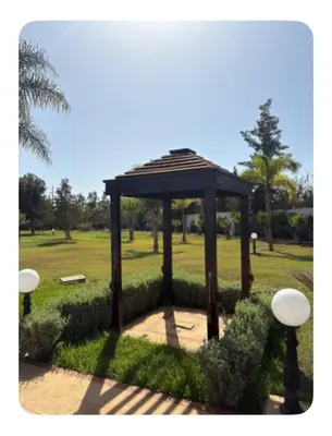 a gazebo in the middle of a park at La Hacienda De Morafia in Bouskoura