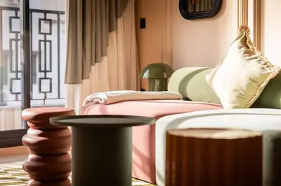a room with a bed and a couch and a window at Résidence Terre de Lys in Casablanca